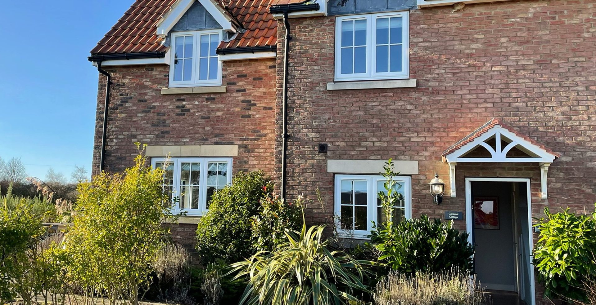The front of Caramel Cottage at The Bay, Filey, with its porch and blue front door
