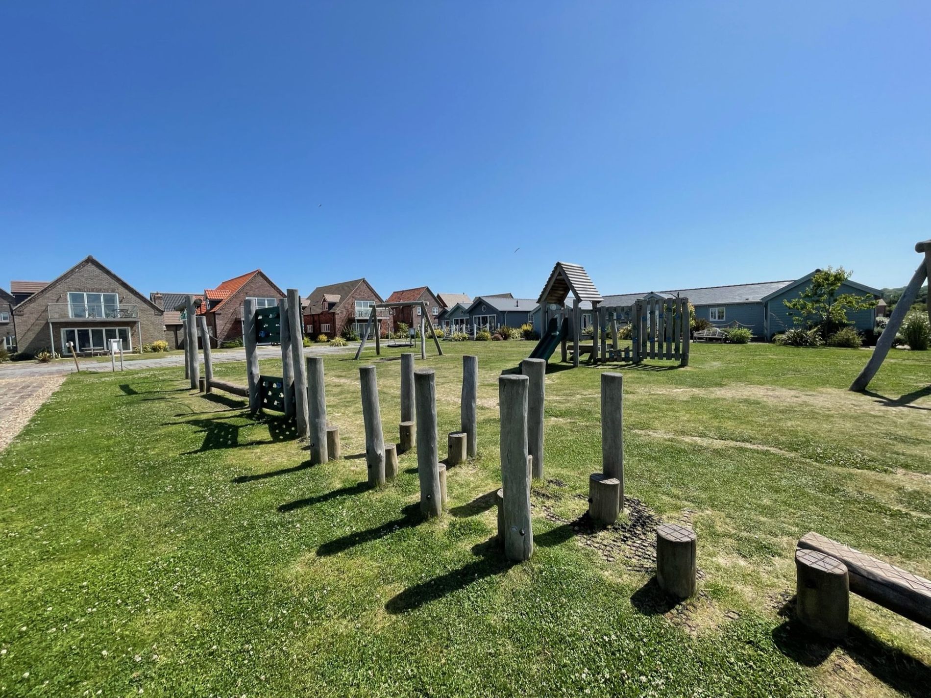 The wooden climbing frame and play area on the green at The Bay, Filey