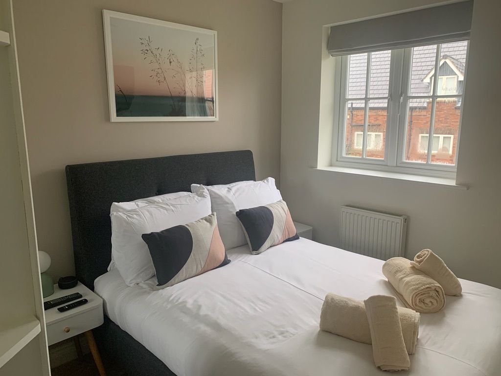 The double bedroom at Caramel Cottage, made up with towels on the bed