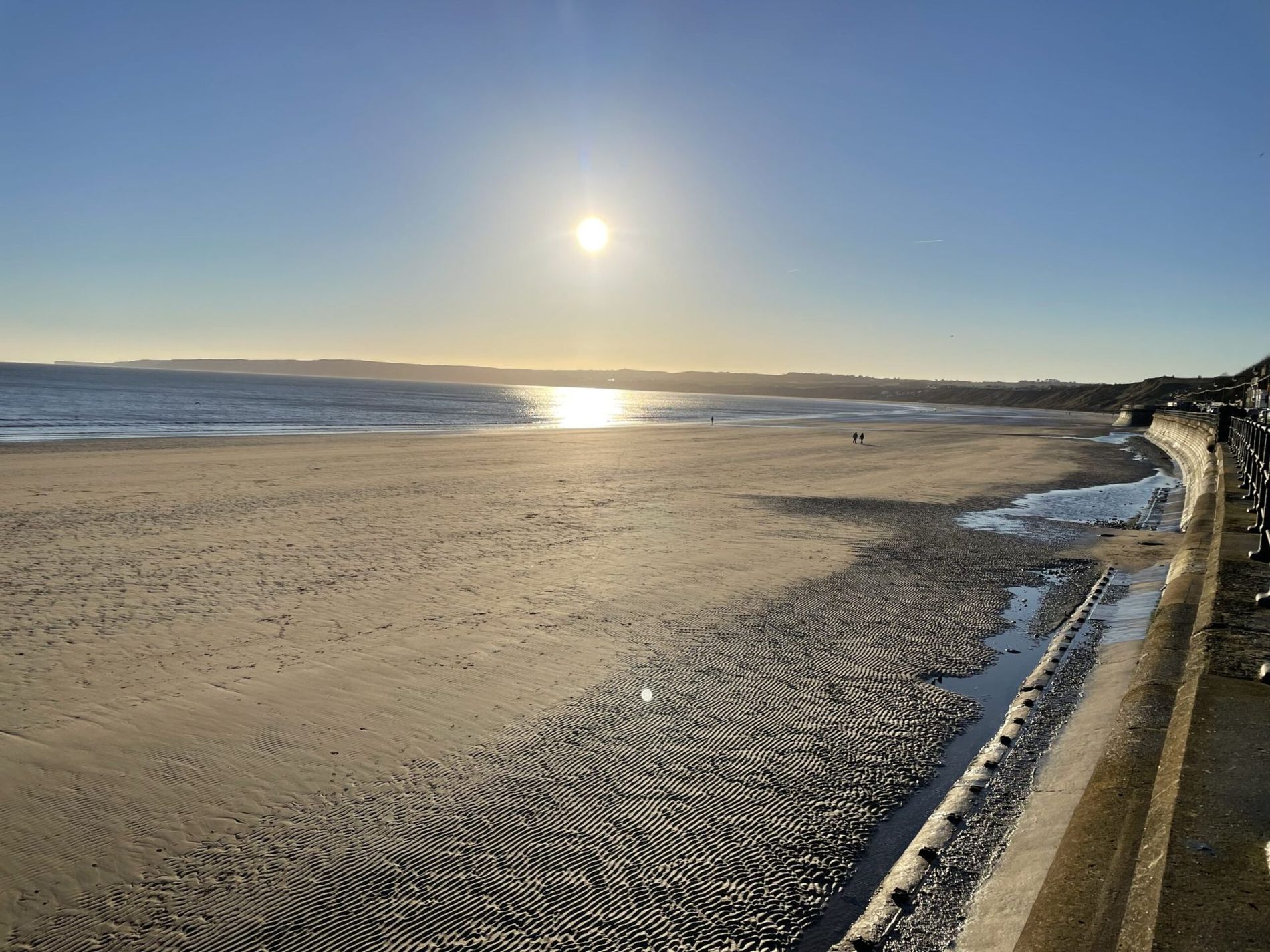 Low sun over the wet sand at Filey beach