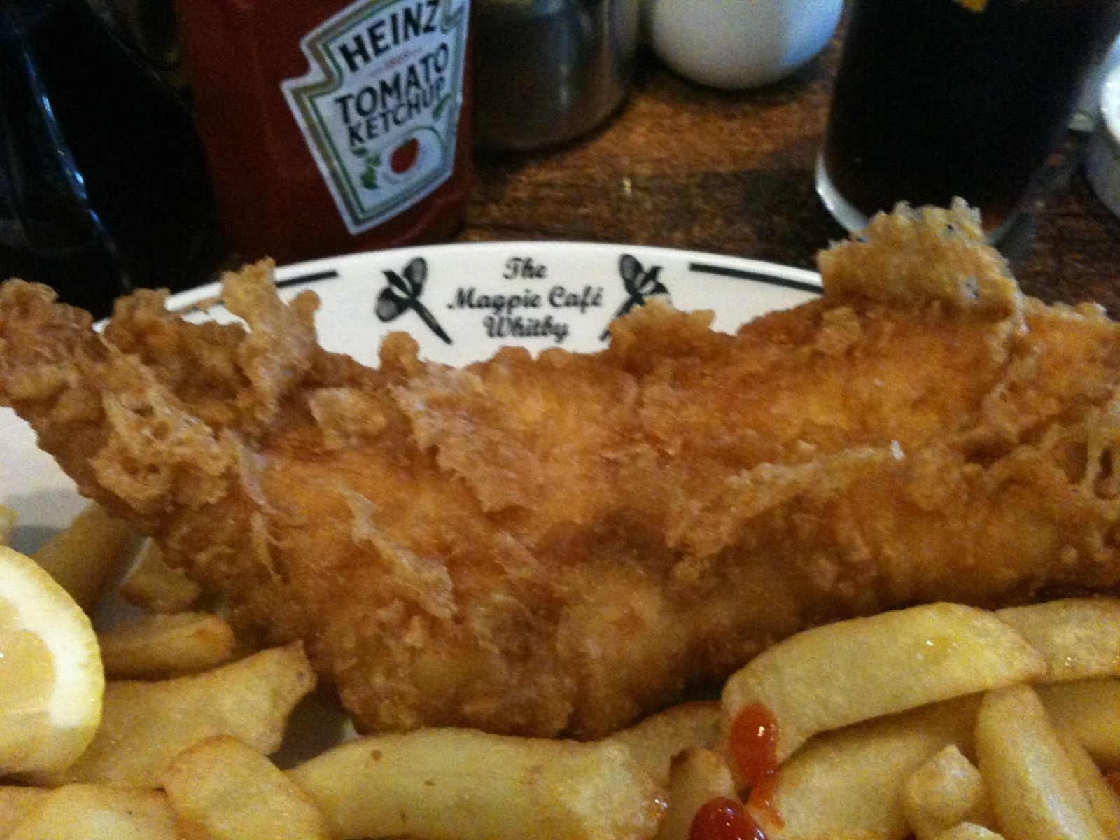 Battered fish and chips on a Magpie Cafe plate in Whitby