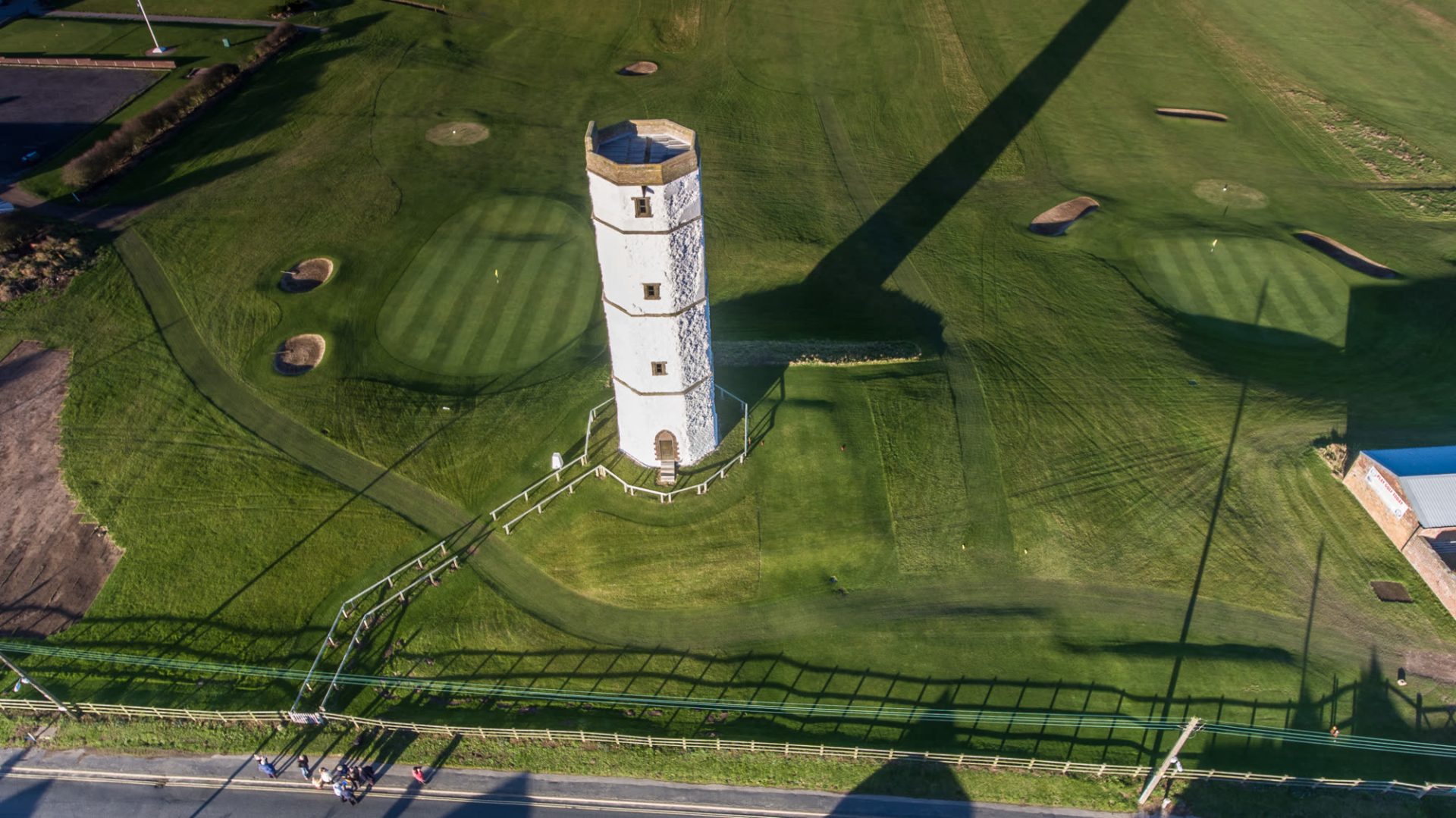 Flamborough Head Golf Club from the air, with the old chalk lighthouse - Caramel Cottage Aerial view of Flamborough Head Golf Club, with the white chalk tower of the old lighthouse standing between two greens