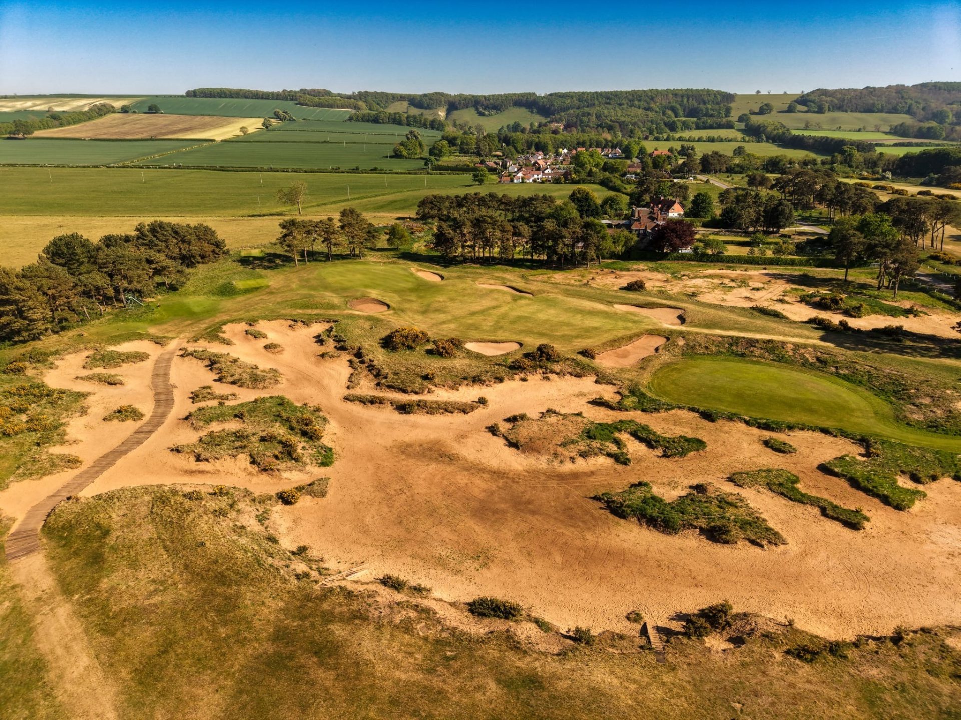 Aerial view of the 17th at Ganton Golf Club with the village and the Wolds behind