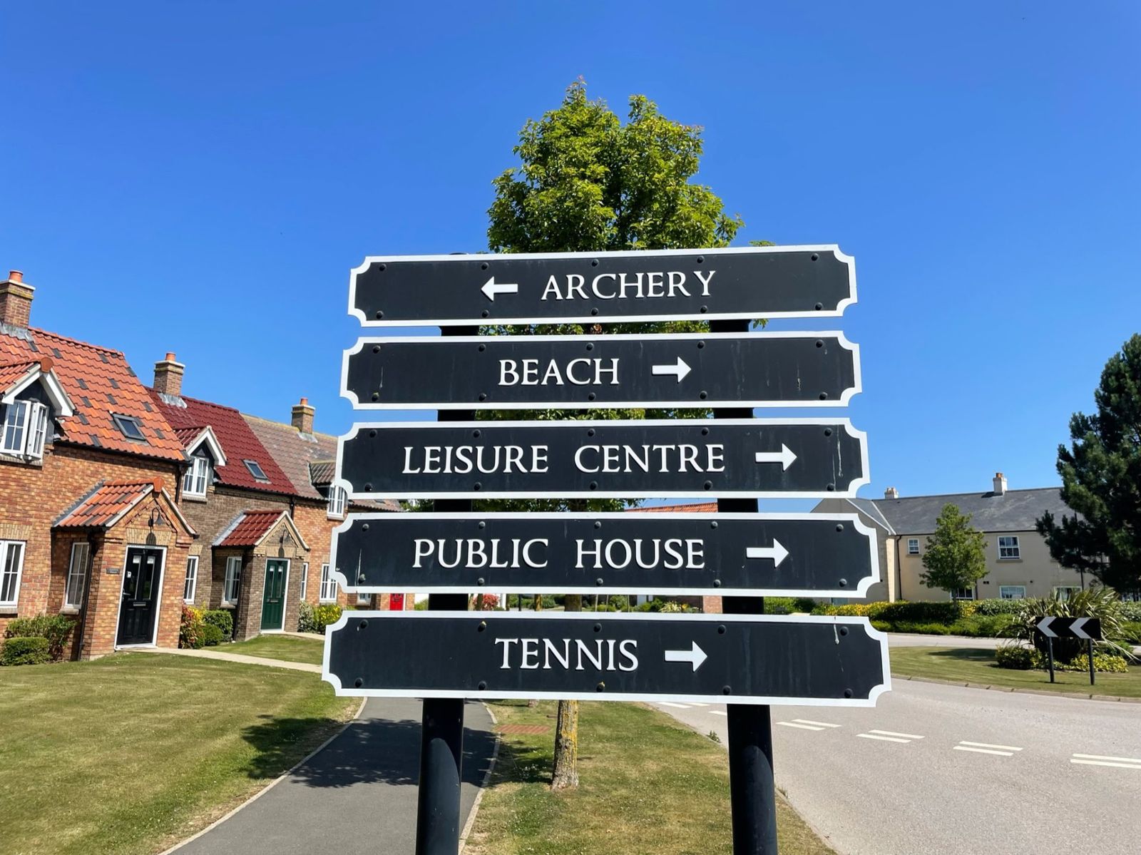 The signpost at The Bay, Filey pointing to the archery, beach, leisure centre, public house and tennis