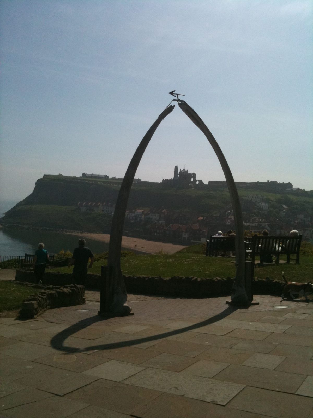 The whalebone arch on the West Cliff at Whitby, framing the abbey across the harbour